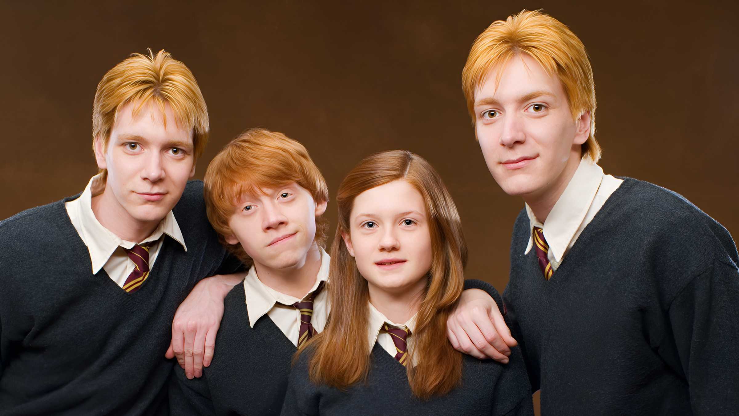 Quatro crianças da família Weasley posando para uma foto em Harry Potter