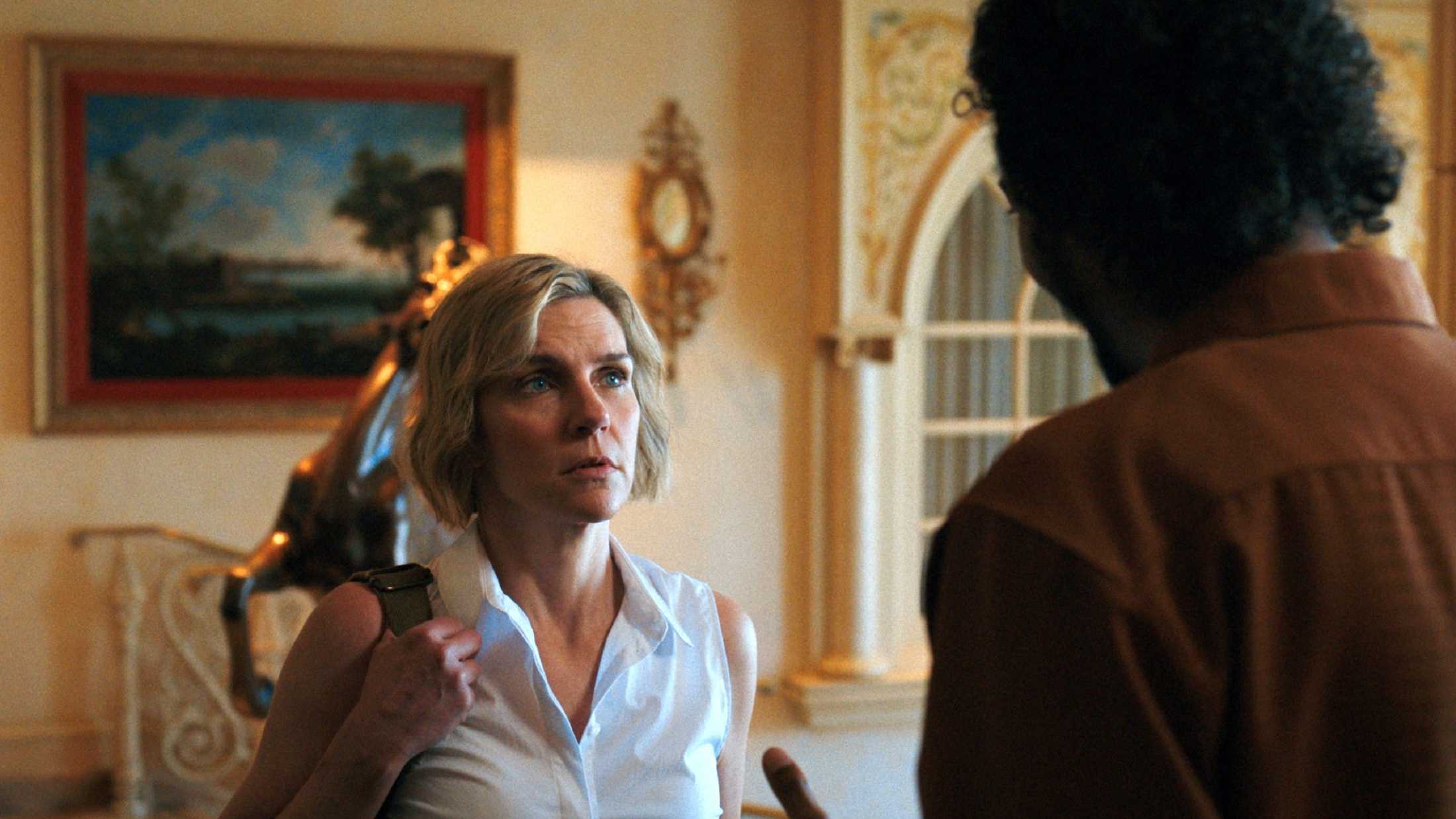 Carol (Rhea Seehorn) looking up at Koumba Diabaté (Samba Schutte) in Pluribus
