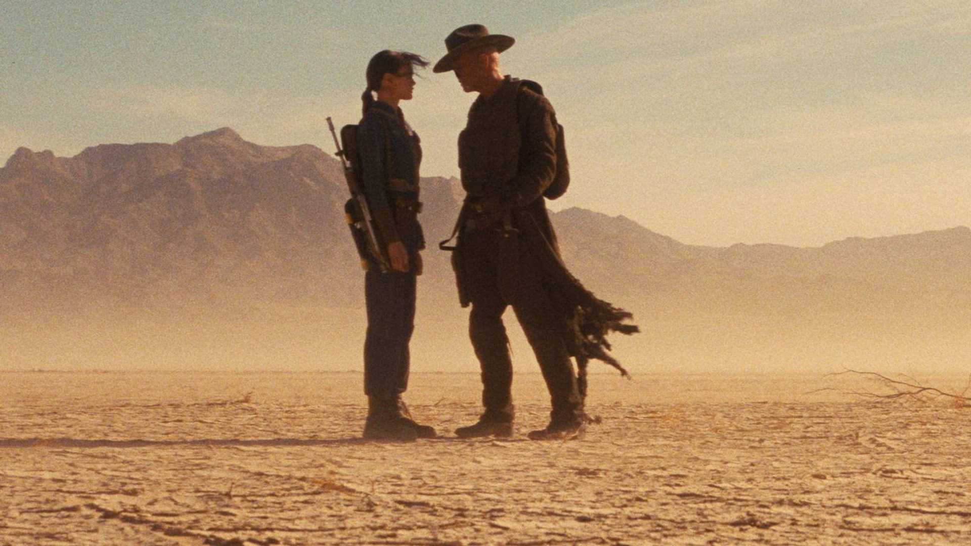 Lucy e o Ghoul frente a frente no deserto de Fallout