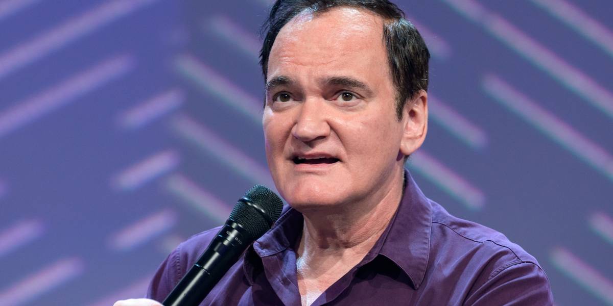 Quentin Tarantino holding a microphone